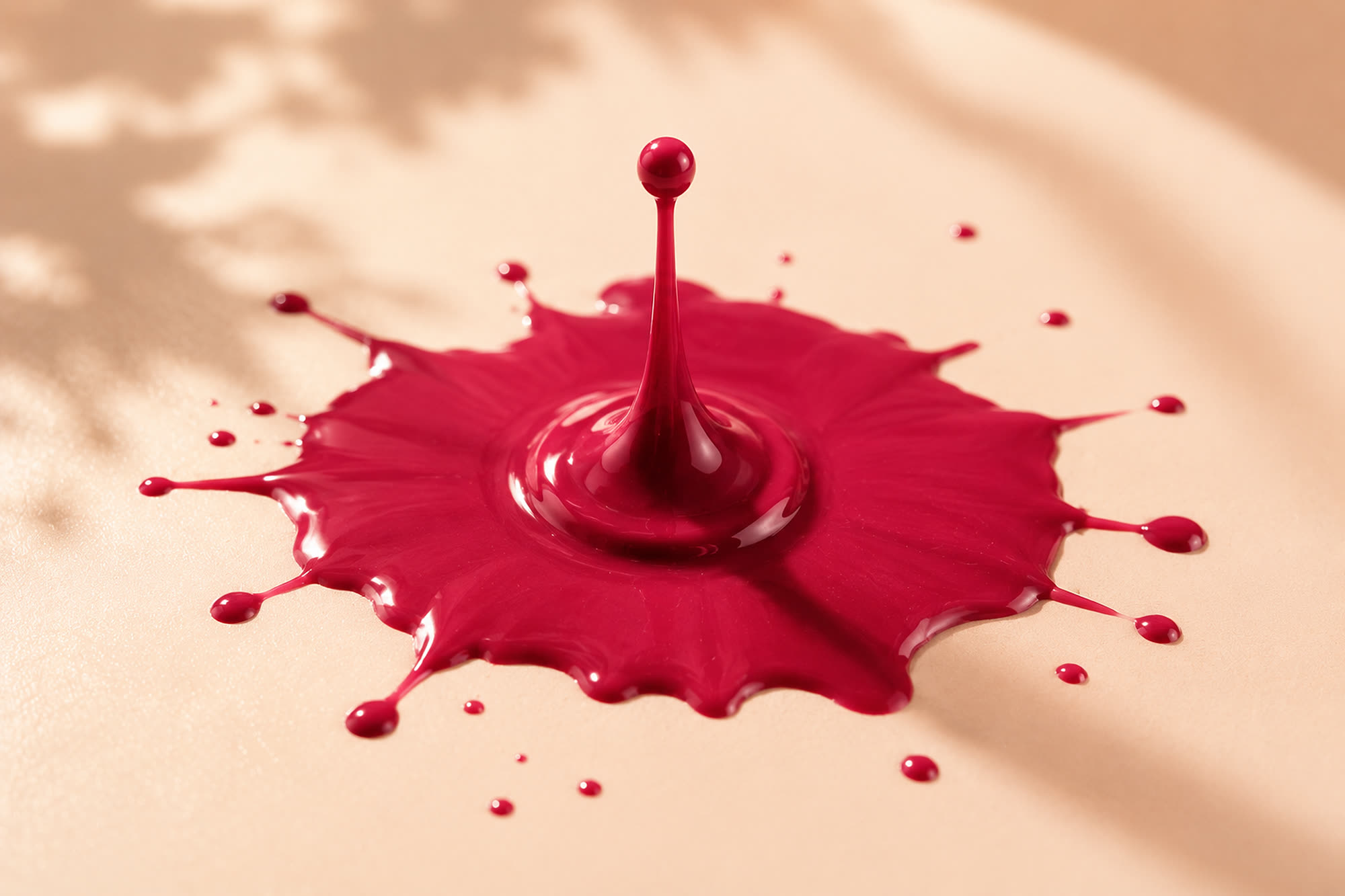 A drop of berry lacquer landing and blooming
